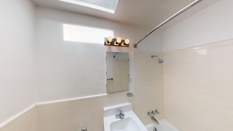a bathroom with a sink and a mirror and a tub