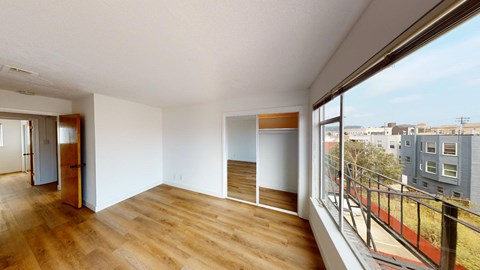 a living room with a large window and a balcony