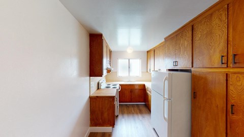 a kitchen with wooden cabinets and a white refrigerator