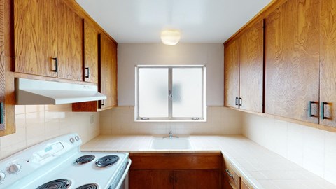 a kitchen with a stove and a window
