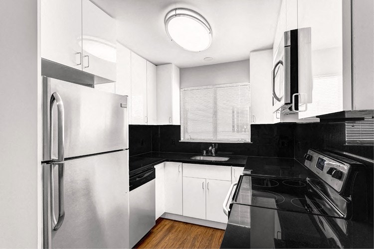 a black and white kitchen with stainless steel appliances