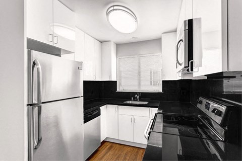 a black and white kitchen with stainless steel appliances
