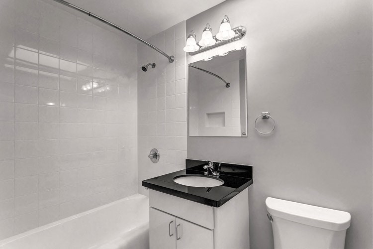 a bathroom with a sink toilet and a mirror