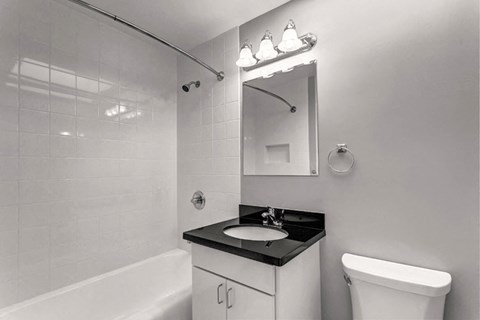 a bathroom with a sink toilet and a mirror