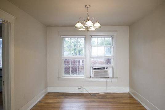 a empty room with a window and three lights