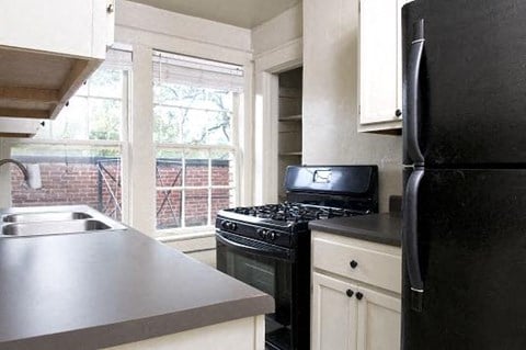 a kitchen with a stove and a refrigerator and a sink