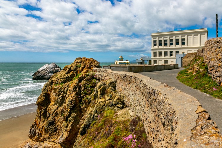 a building on a cliff overlooking the ocean