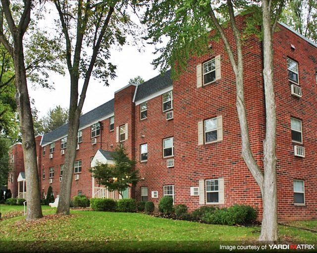 a red brick building with trees in front of it