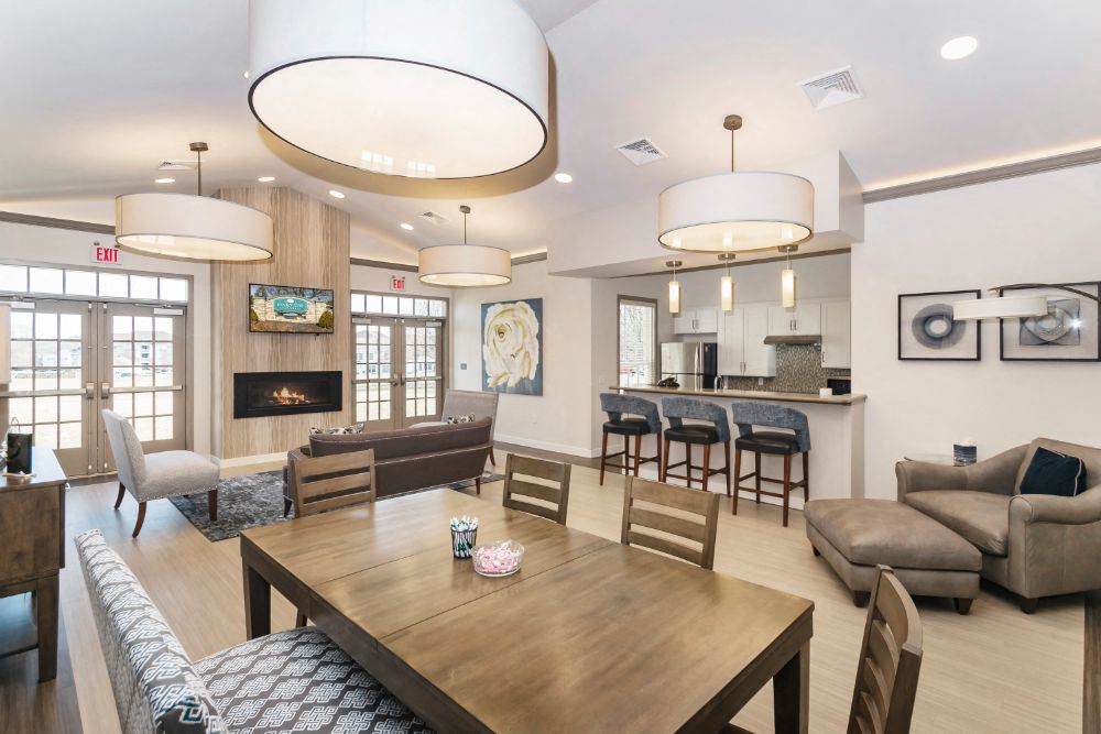 A modern dining room with a wooden table and chairs.