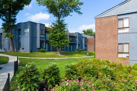 A building with a green lawn in front of it.