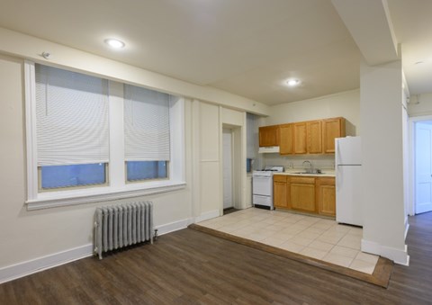 A kitchen with wooden cabinets and a white refrigerator.