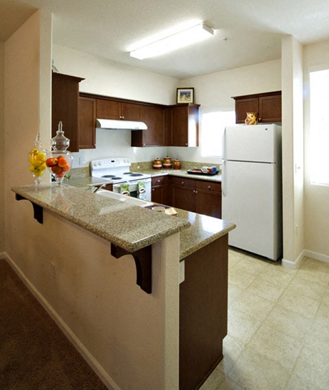 a kitchen with a counter top and a refrigerator