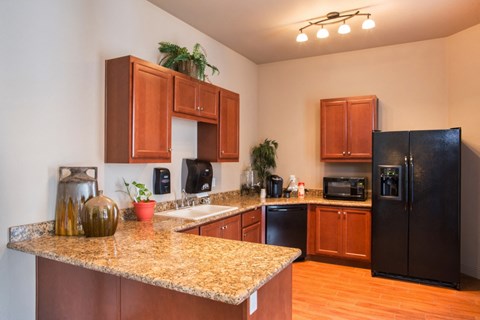 a kitchen with granite counter tops and black appliances