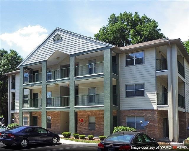 a apartment building with cars parked in front of it