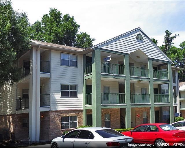 a apartment building with cars parked in front of it