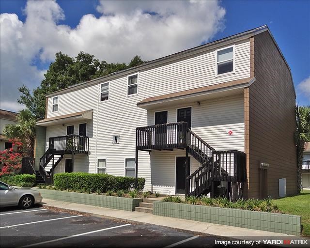 a white apartment building with two sets of stairs