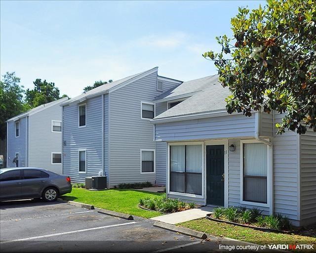 a car parked in front of a white house