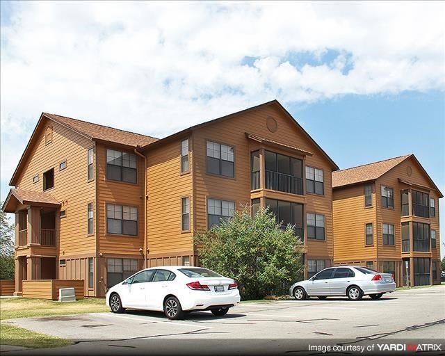 two cars parked in front of an apartment building