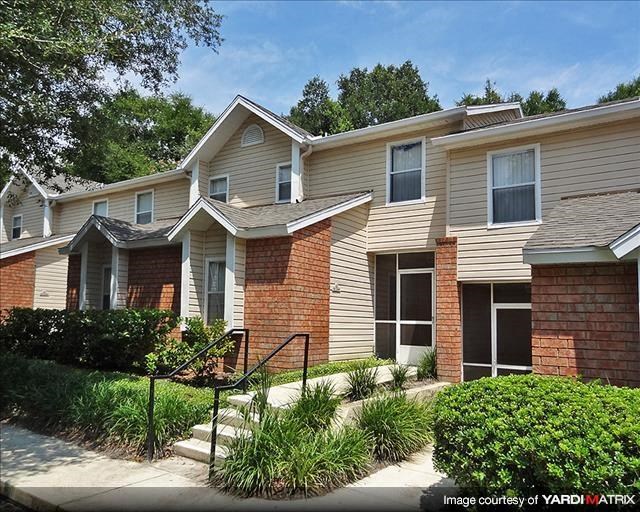 a brick house with a staircase in front of it
