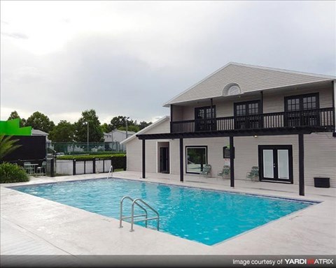 a large swimming pool in front of a house