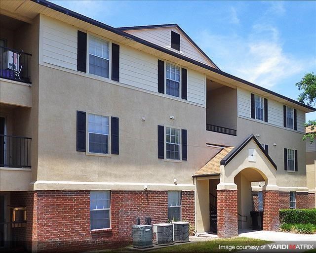 a large apartment building with brick and white walls