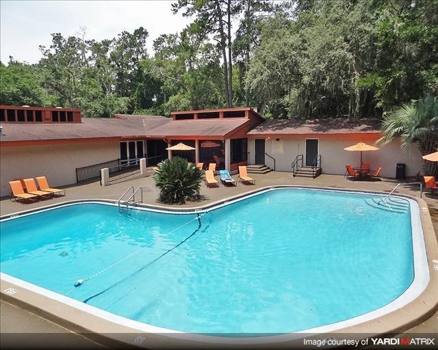 a large swimming pool in front of a hotel