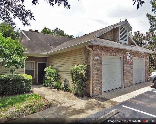 a small house with two garage doors