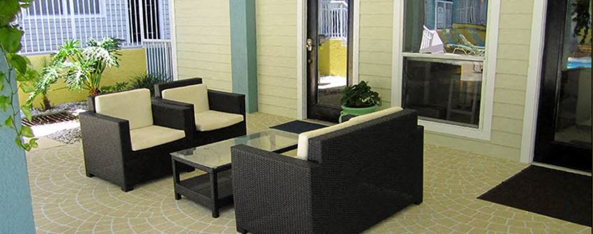 a patio with a table and chairs on it