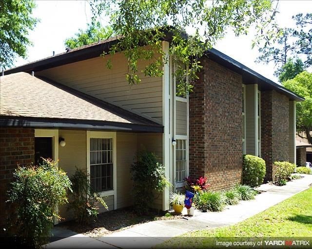 a small house with a sidewalk in front of it