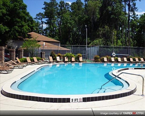 a large swimming pool with chairs around it