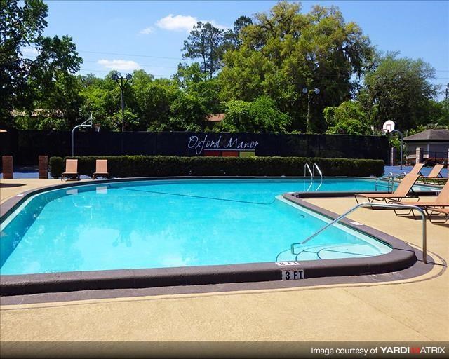 a large swimming pool with chairs around it