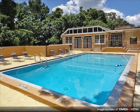 a large swimming pool with chairs around it