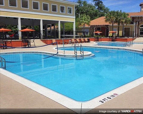 a large blue swimming pool in front of a building