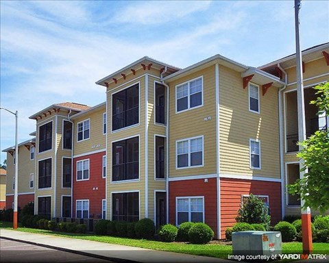 a row of apartment buildings on the side of a street