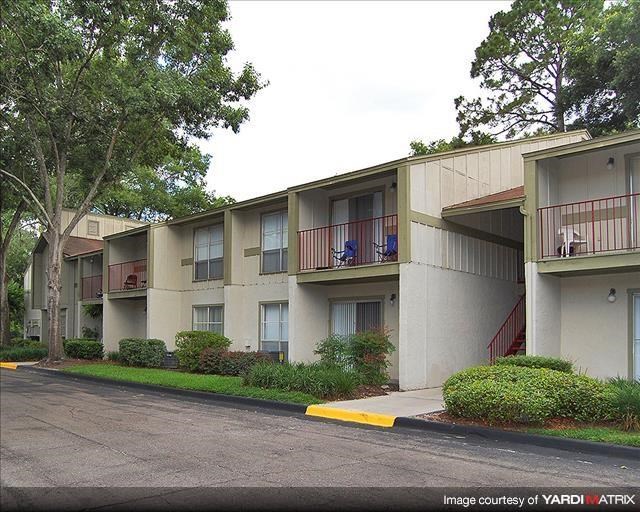 an apartment building with balconies and trees