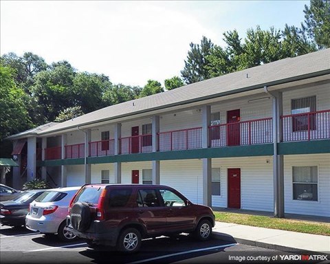 a building with cars parked in a parking lot