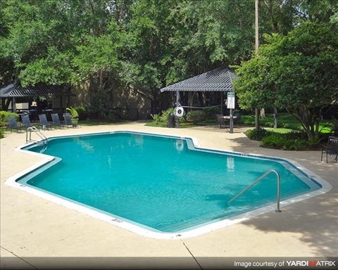 a blue swimming pool next to a resort pool