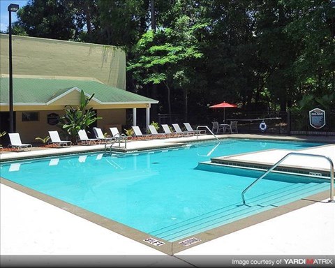 a large swimming pool with chairs around it