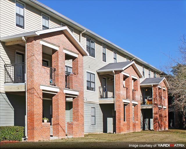 a brick apartment building with two balconies