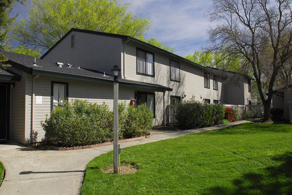 Exterior building near landscape grass  l Pepperwood Apartments in Davis CA