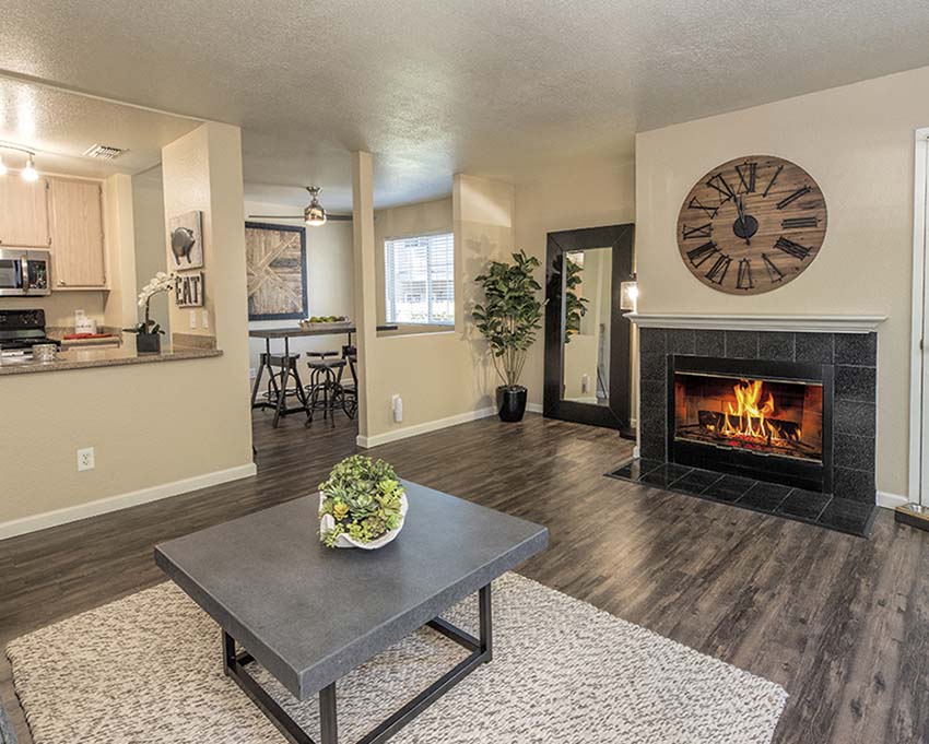 Living room with fireplace and view of dining and kitchen l Foxborough Apartments