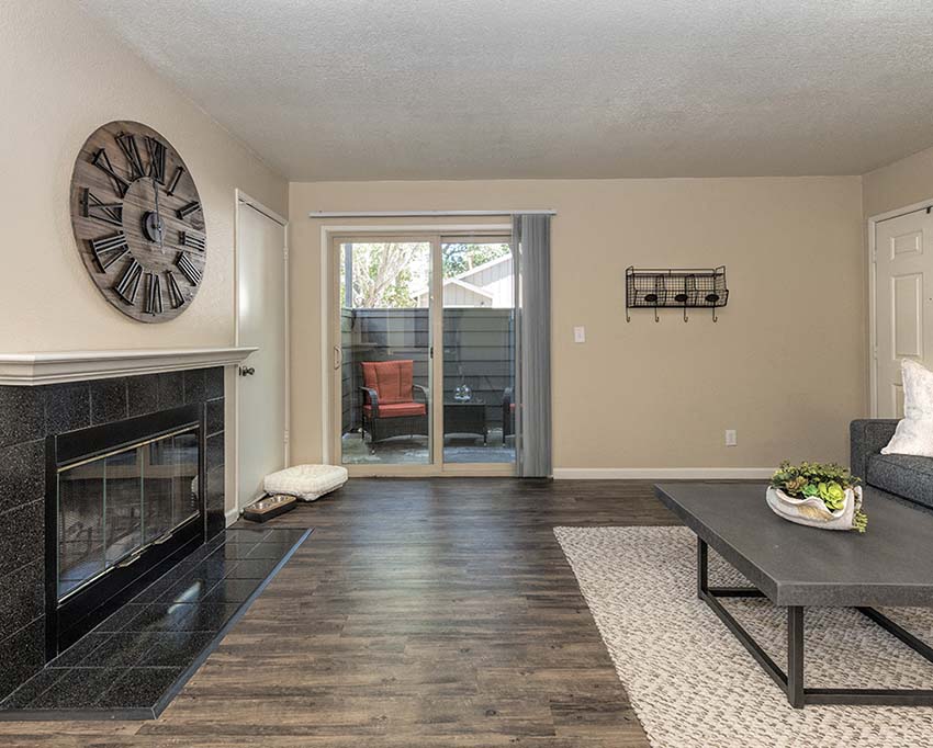 Living room with fireplace and patio l Foxborough Apartments