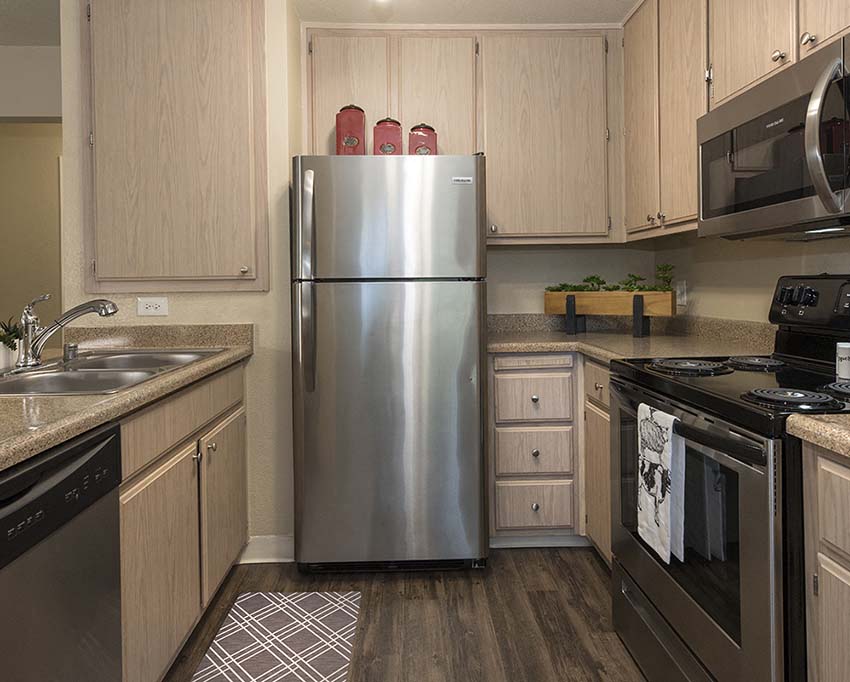 Citrus Heights, CA Apartments - Foxborough - Kitchen with Stainless Steel Appliances, Wood Flooring, and Natural Cabinets