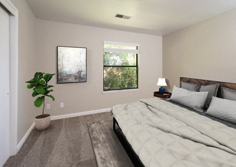 a bedroom with a large bed and a potted plant