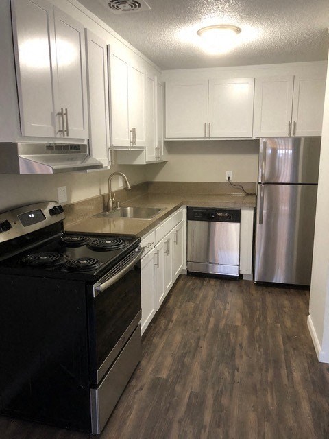 Apartments for Rent in Walnut Creek - Creekside Terrace - Kitchen with Stainless-Steel Appliances, White Cabinets, and Spacious Countertops