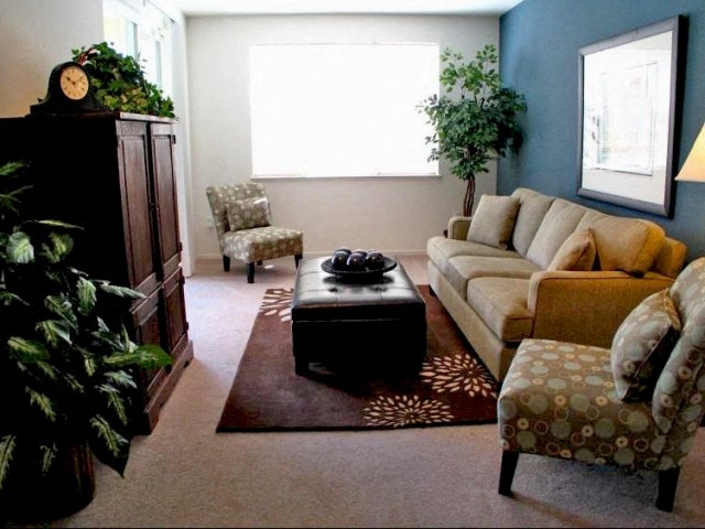 a living room with a couch and chairs and a table