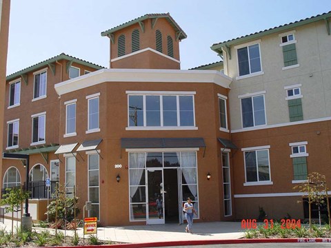 A building with a brown facade and a green roof.