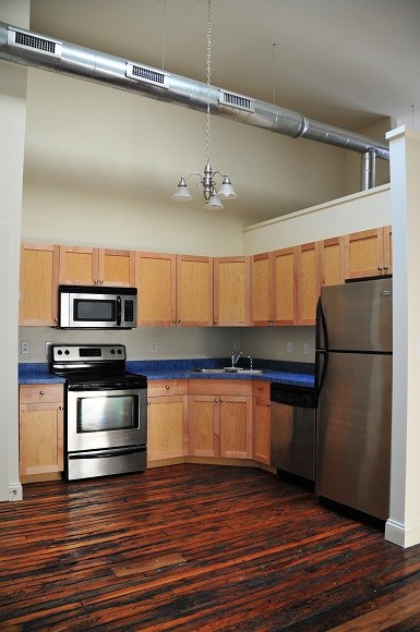 a kitchen with stainless steel appliances and wooden cabinets