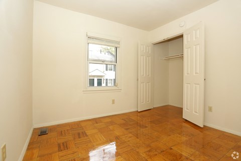 a living room with wood floors and a door and a window