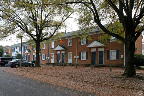 a large brick building with cars parked in front of it